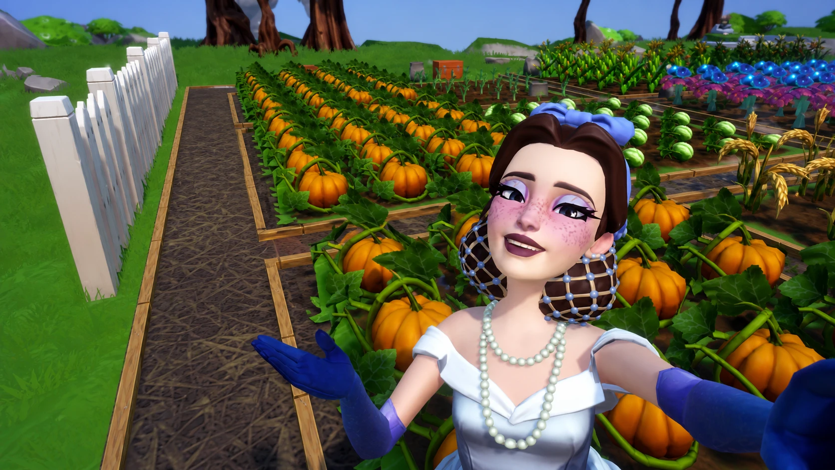 Player taking picture with field of pumpkins in disney dreamlight valley