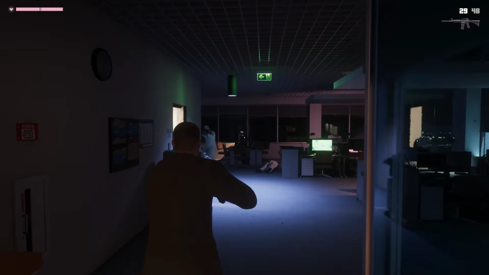 Character aiming a rifle down a dark office hallway under a green exit sign