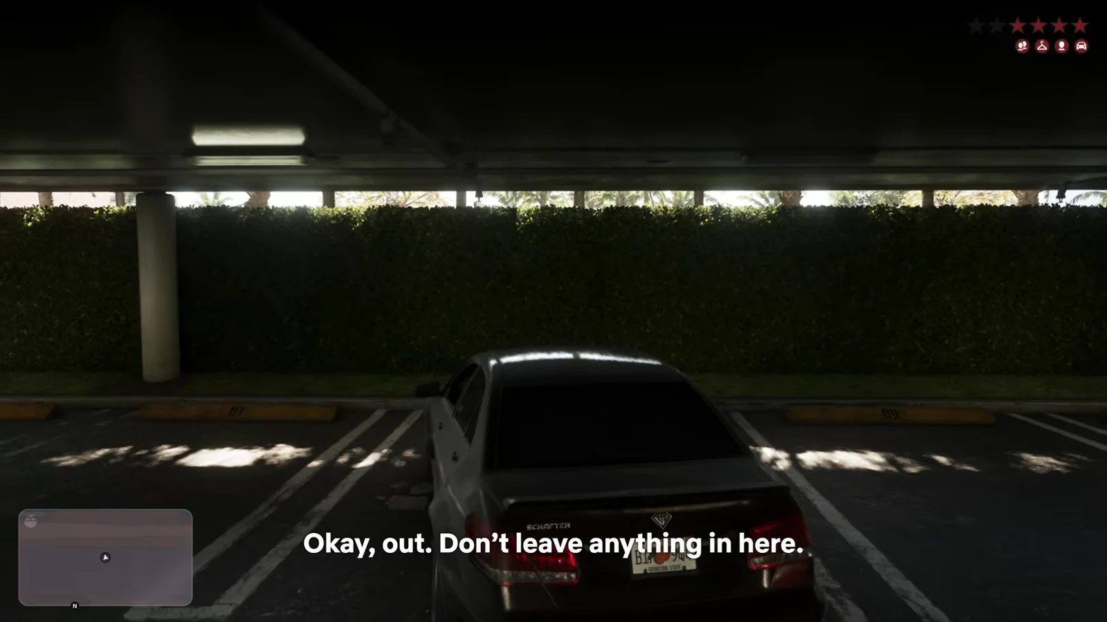 Car stopped in a parking garage with minimap and wanted-level HUD on screen
