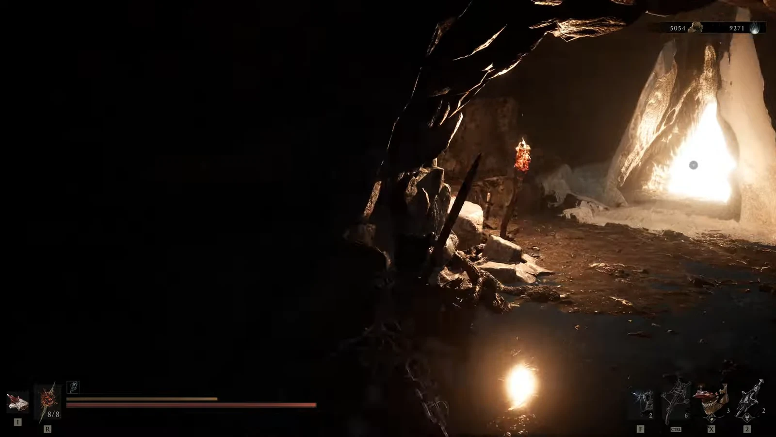 Harbinger walking through a dark cave toward a bright opening with the HUD visible