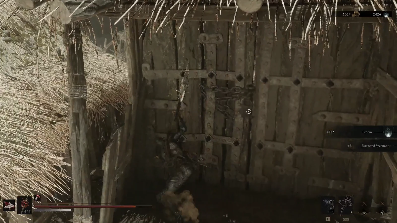 Character interacting with a chained wooden gate as loot notifications appear on screen