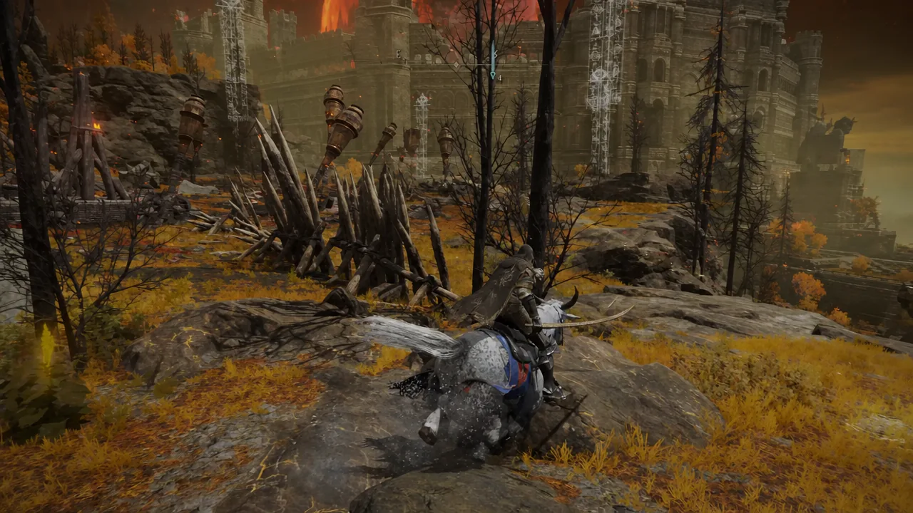 Player riding Torrent across rocky Caelid ground toward the walls of the Caelid Colosseum