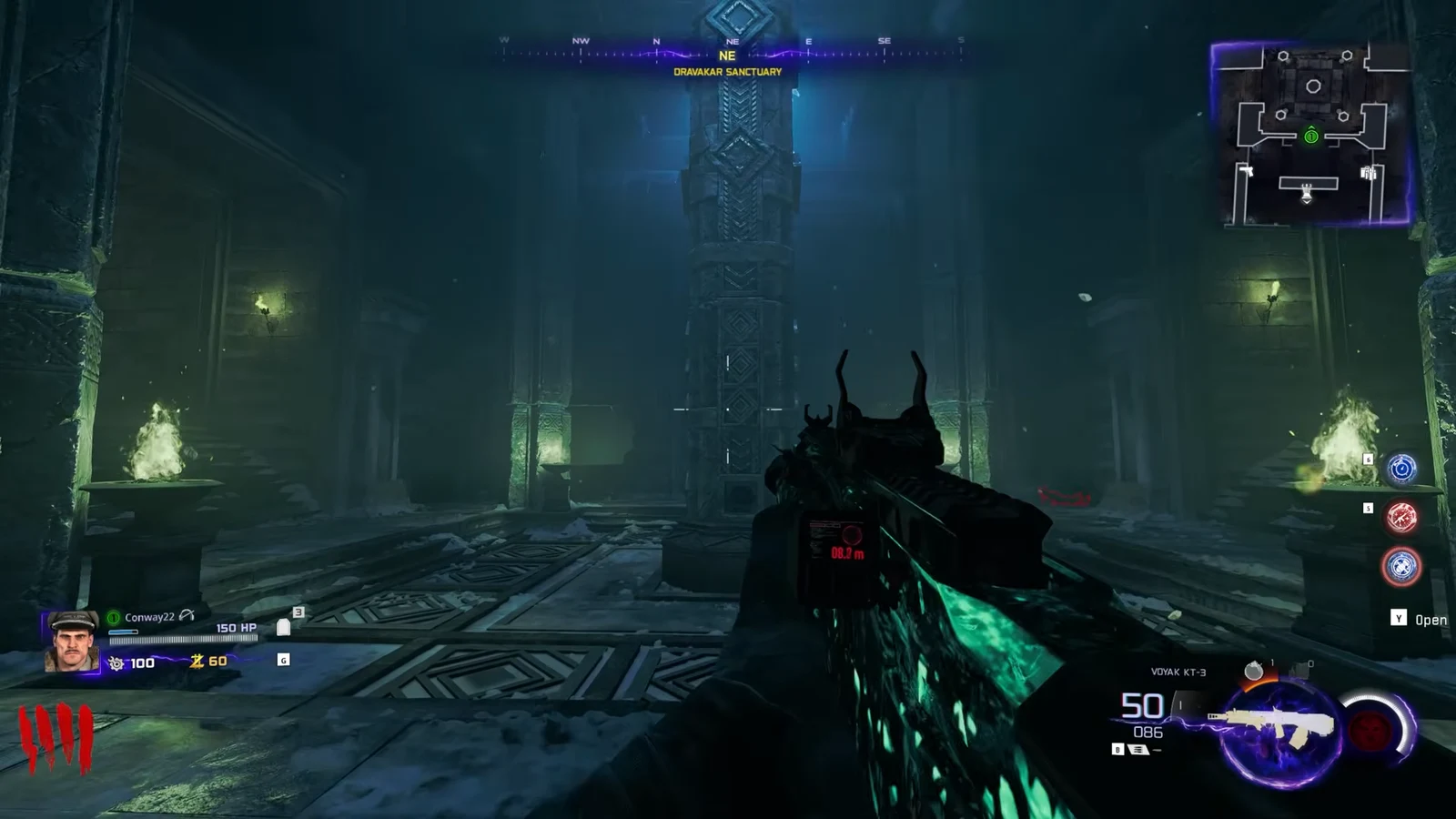 Player holds the VOMAK KT-3 facing a central pillar in Dravakar Sanctuary with a Y Open prompt