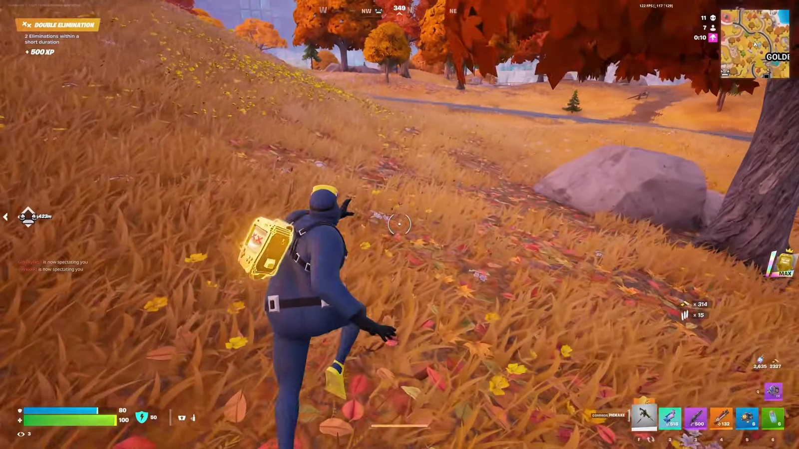 Fortnite player moving through autumn grass toward a road with the crosshair centered