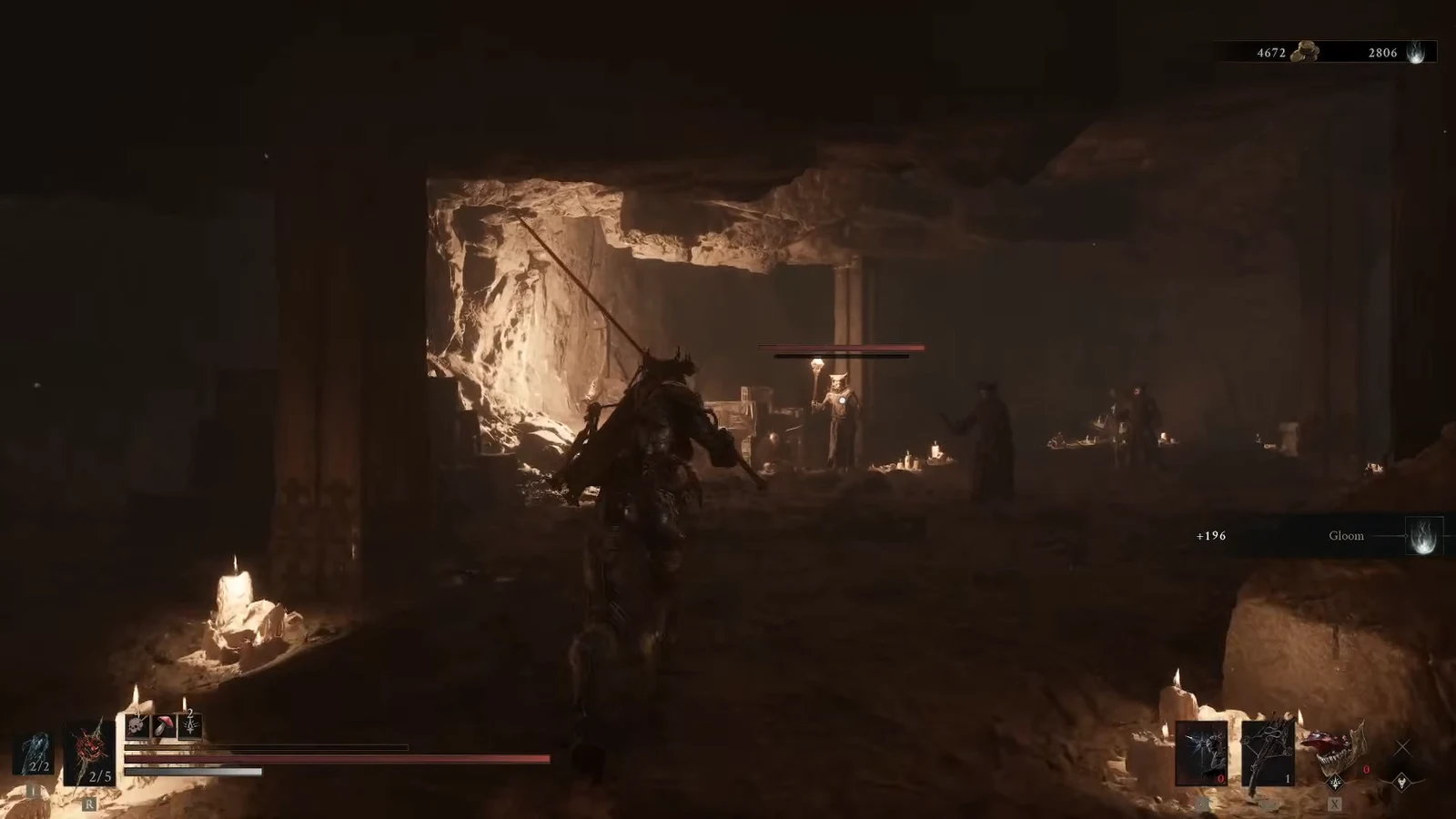 Character approaching several cultist enemies in a candlelit cave chamber with an enemy health bar showing