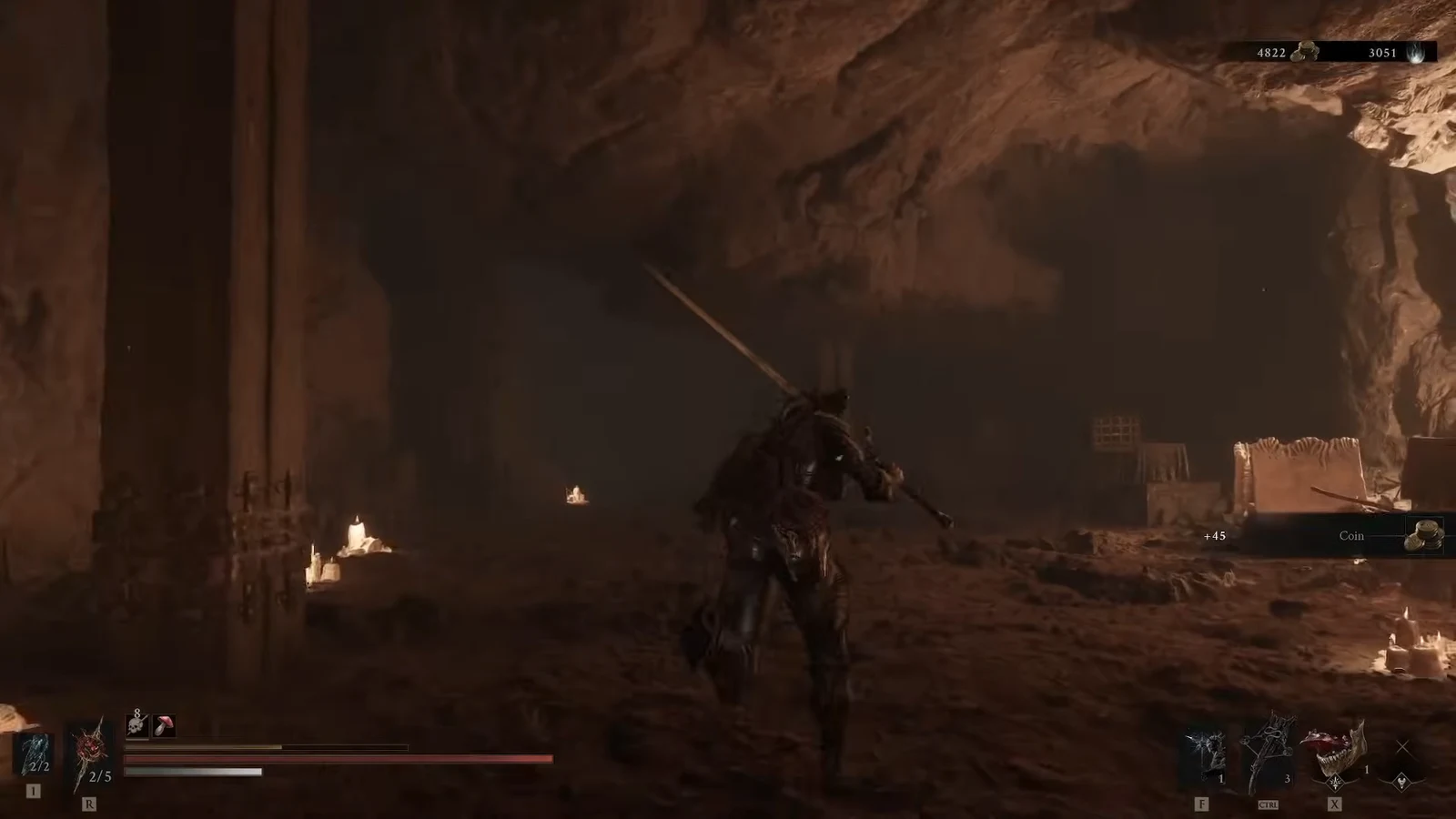 Armored character in the cavern as a plus 45 Coin pickup notification appears near the exit