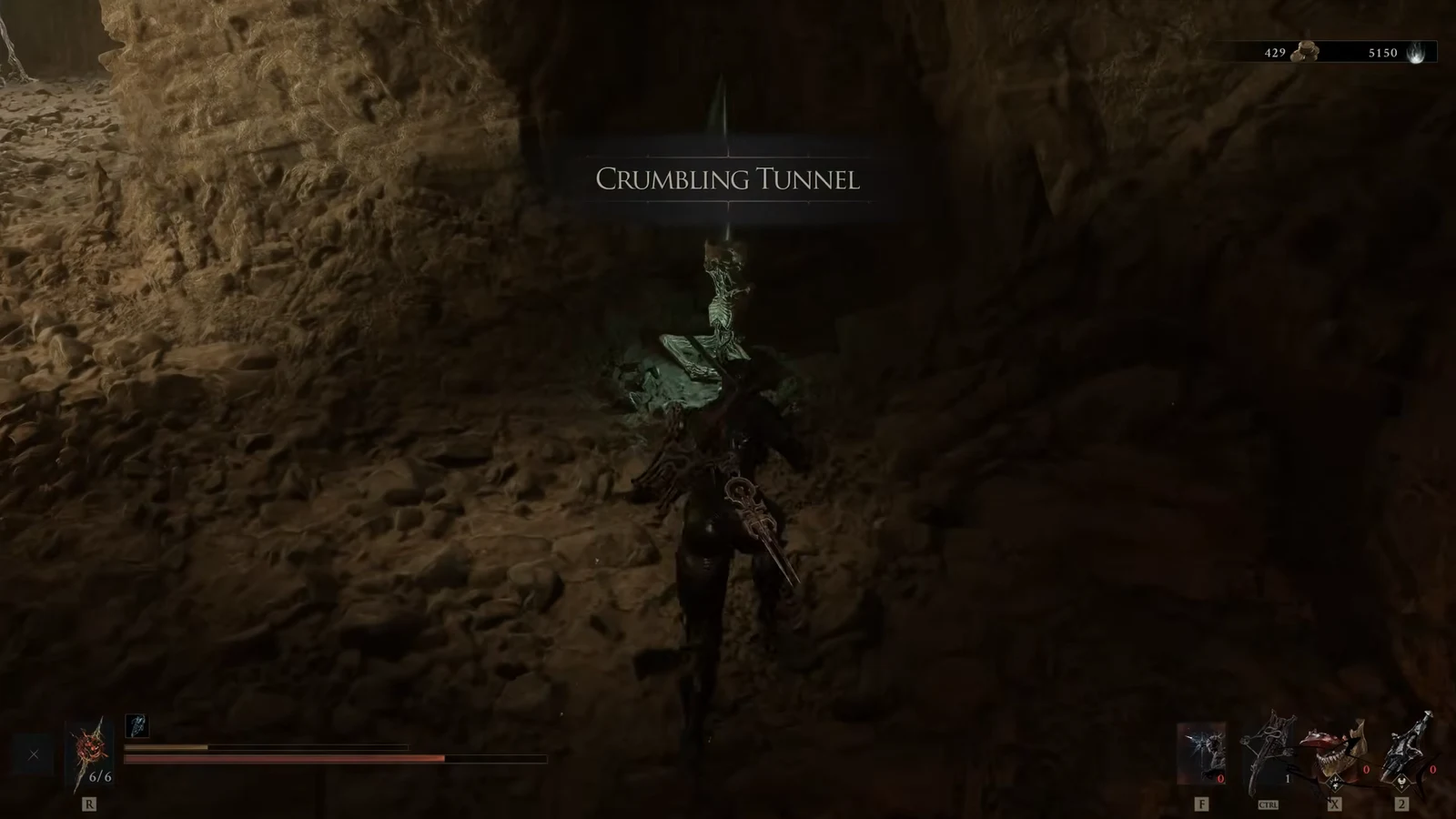 Crumbling Tunnel location title appearing as the character enters the cave