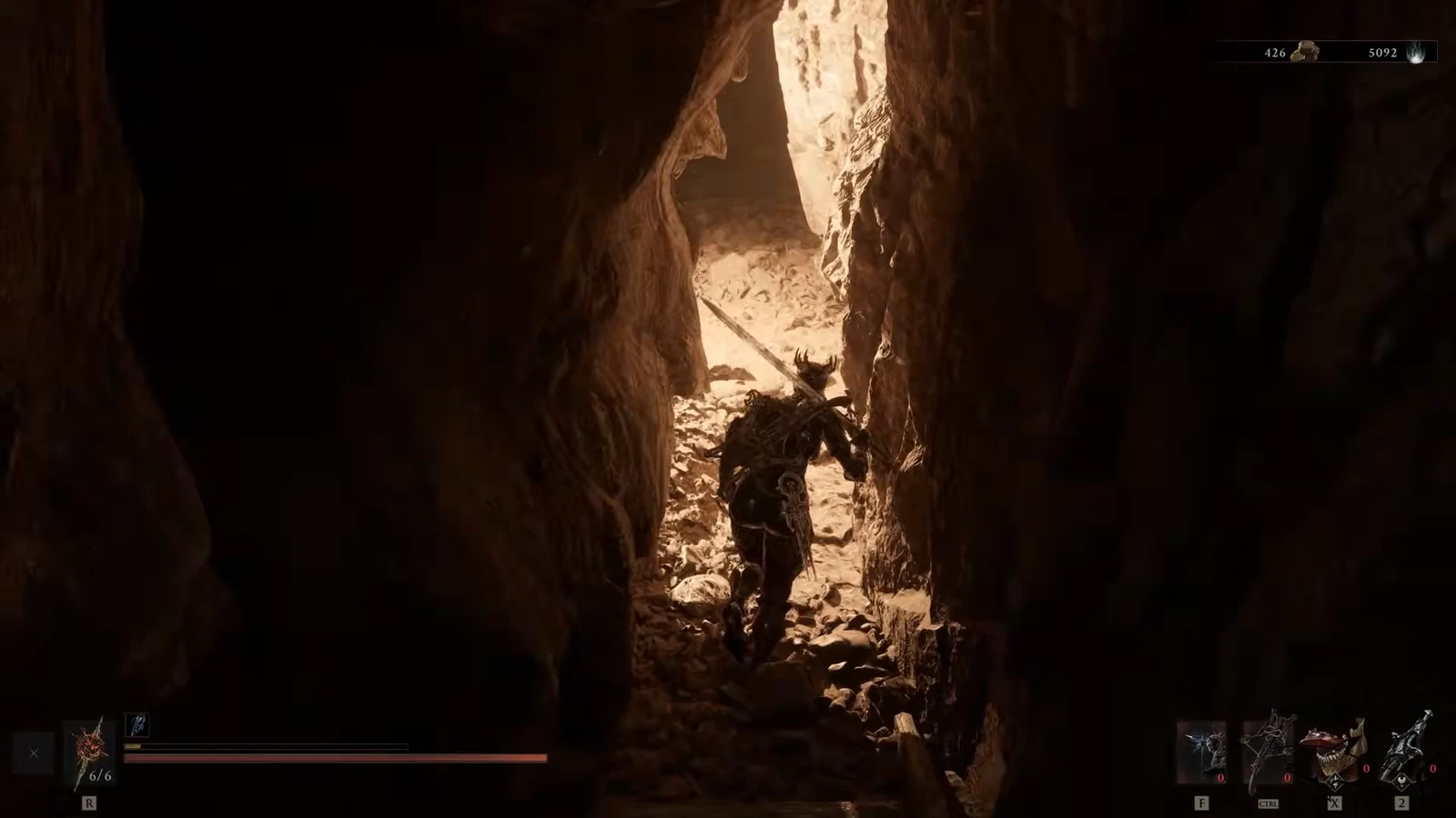Character moving through a narrow rocky cave passage toward a lit opening
