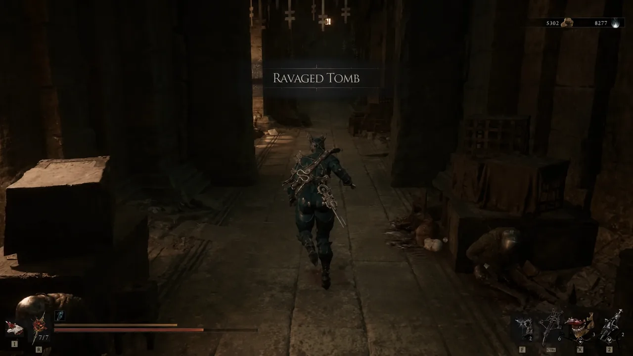 Player character running down a dark corridor inside the Ravaged Tomb