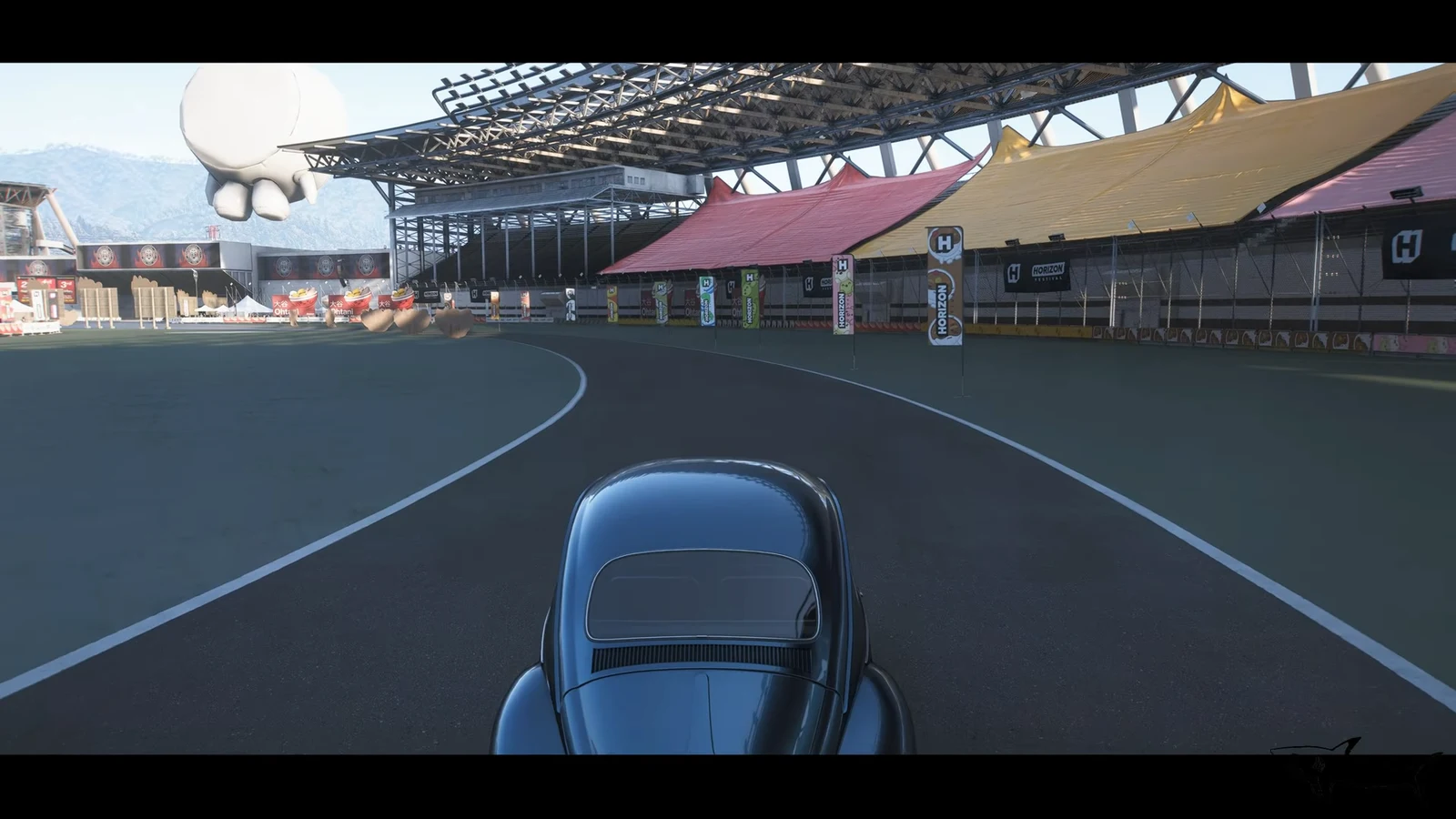 A car driving through a curved section of the Edamame Time Attack circuit inside the festival stadium