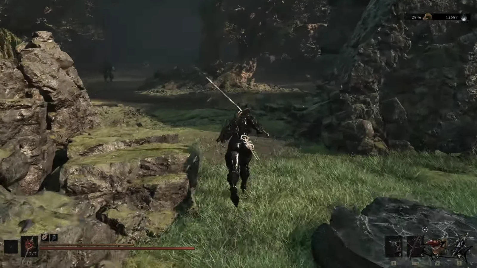 Armored character with sword drawn crossing a grassy, rocky canyon toward the trial