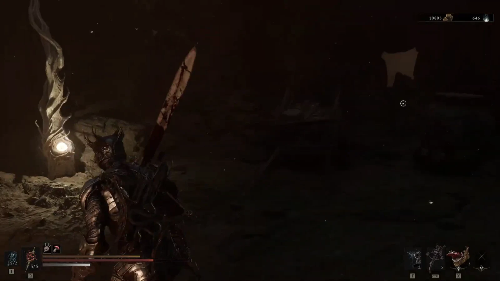 Character heading toward a small glowing marker in a dark cavern with weapon and item HUD