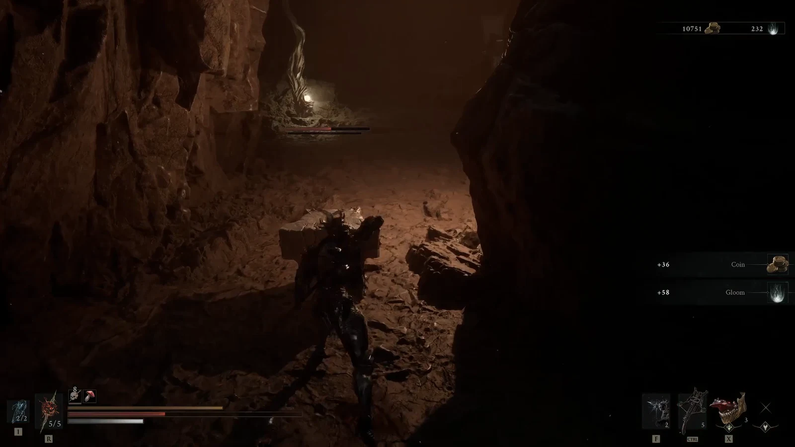 Character approaching a wounded enemy in a dark cavern with Coin and Gloom rewards on screen