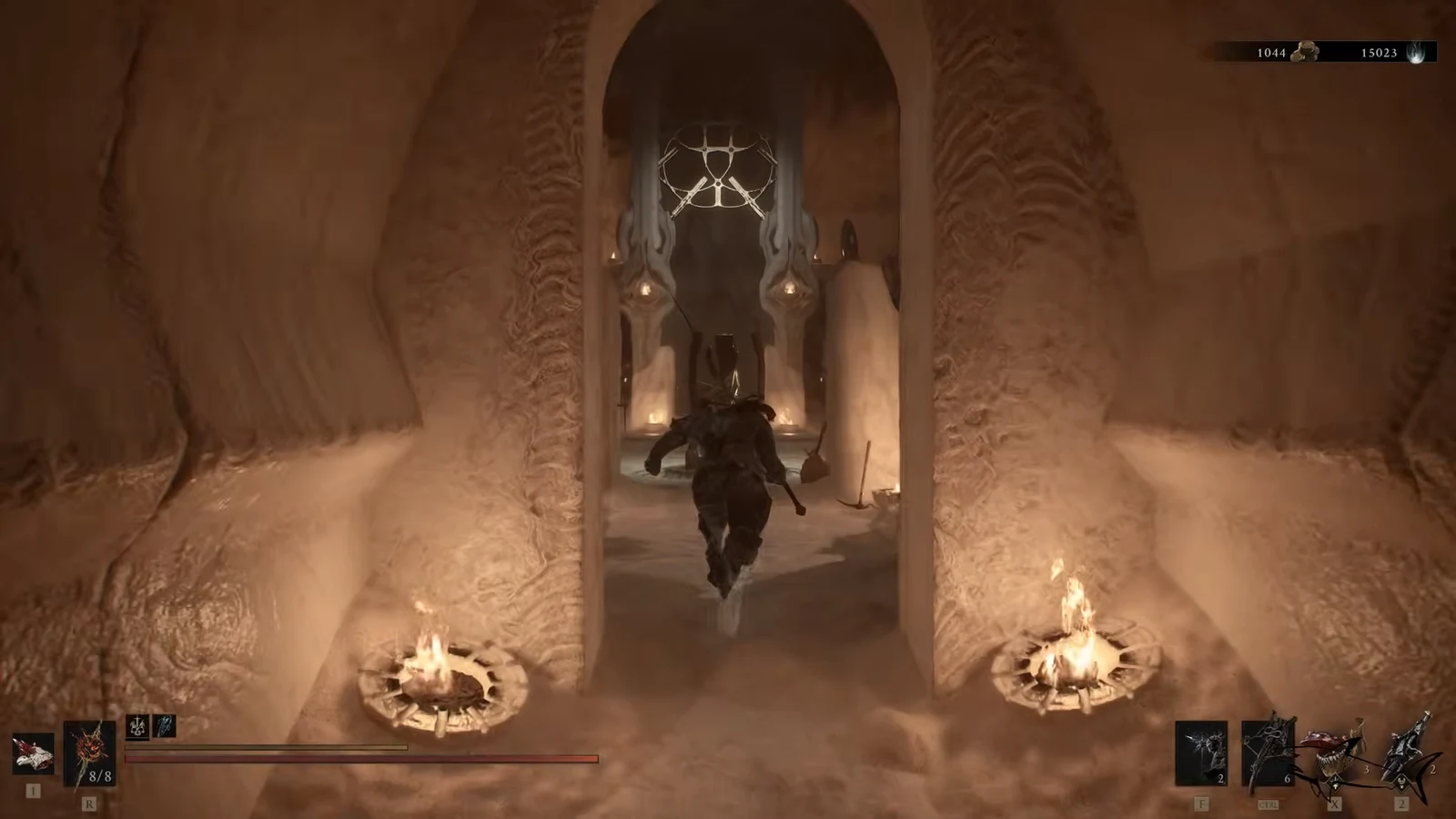 Character sprinting through a lit stone archway on the way to the Shellkeeper's chamber
