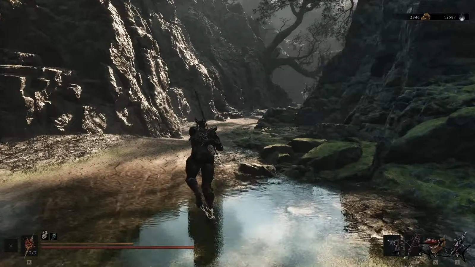 Mounted character rides through a shallow stream along a rocky forest path near the trial area