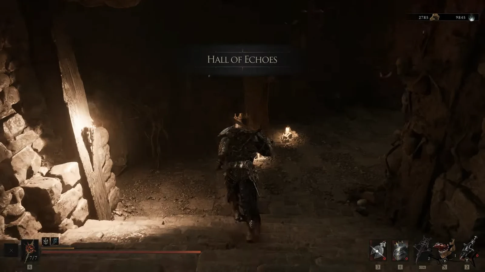 Armored character exploring a torch-lit cavern passage in the Hall of Echoes