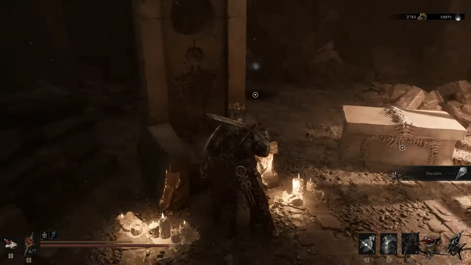 Candlelit tomb with a plus one Dorsalite pickup notification on screen