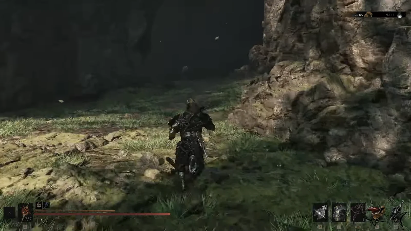Armored character running through a rocky area toward a dark cave entrance