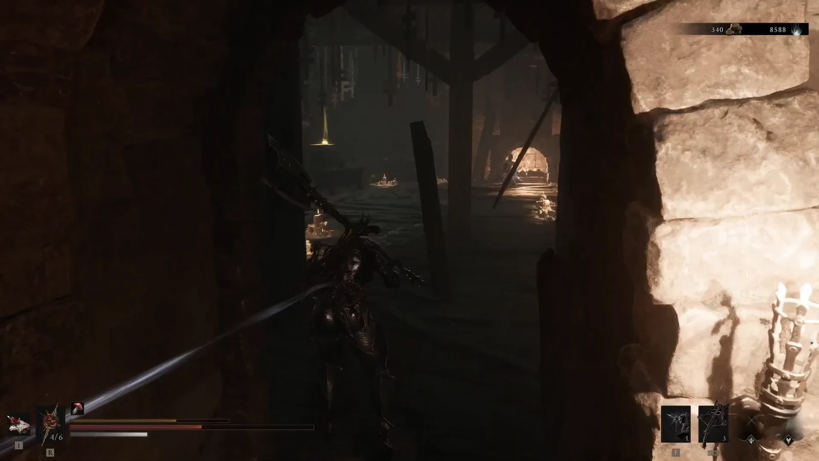 Dark-armored character walking through a stone doorway into a candlelit chamber