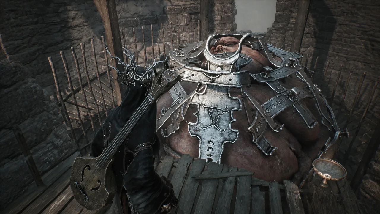 An armored beast penned behind wooden stakes in a stone enclosure off the main path