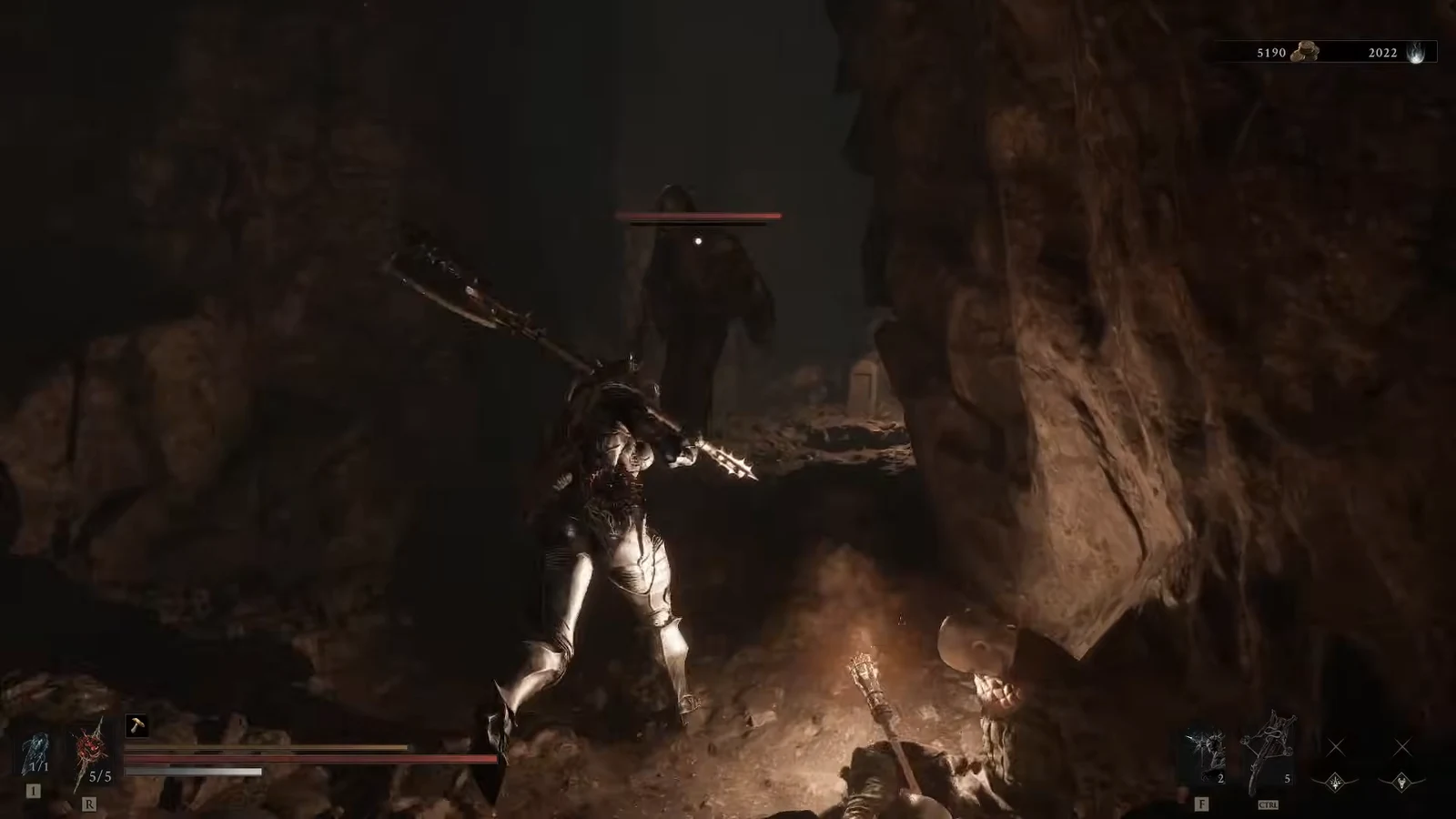 Player swings at an enemy with a red health bar in a dimly lit cavern