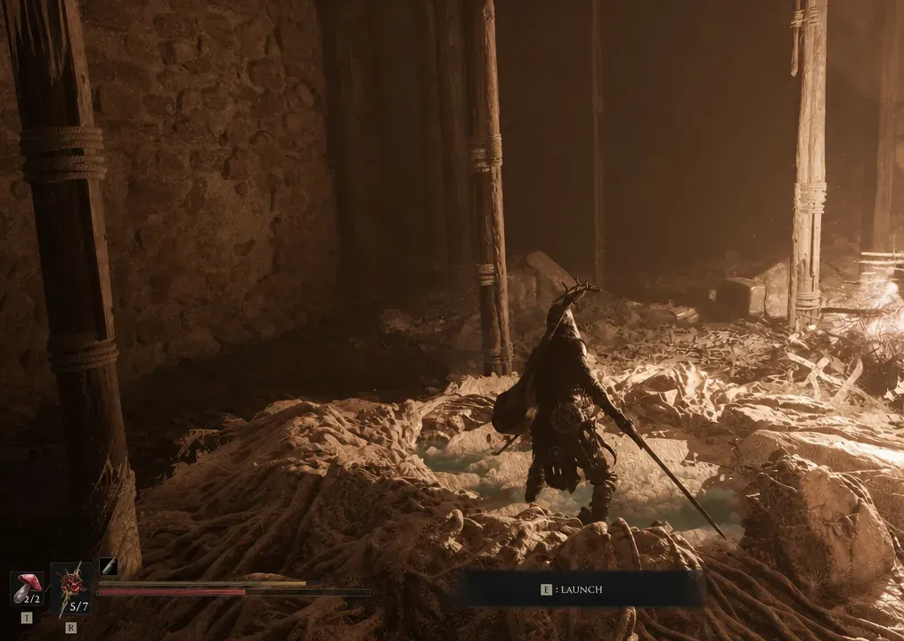 Gameplay screen showing the E: LAUNCH prompt at the updraft beside the fire pit