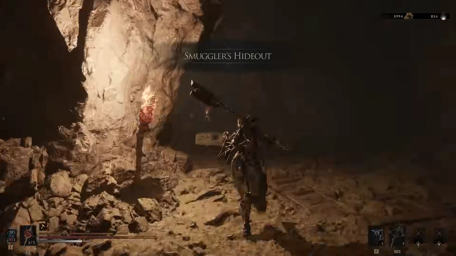 Player moving through a rocky underground passage with weapons ready