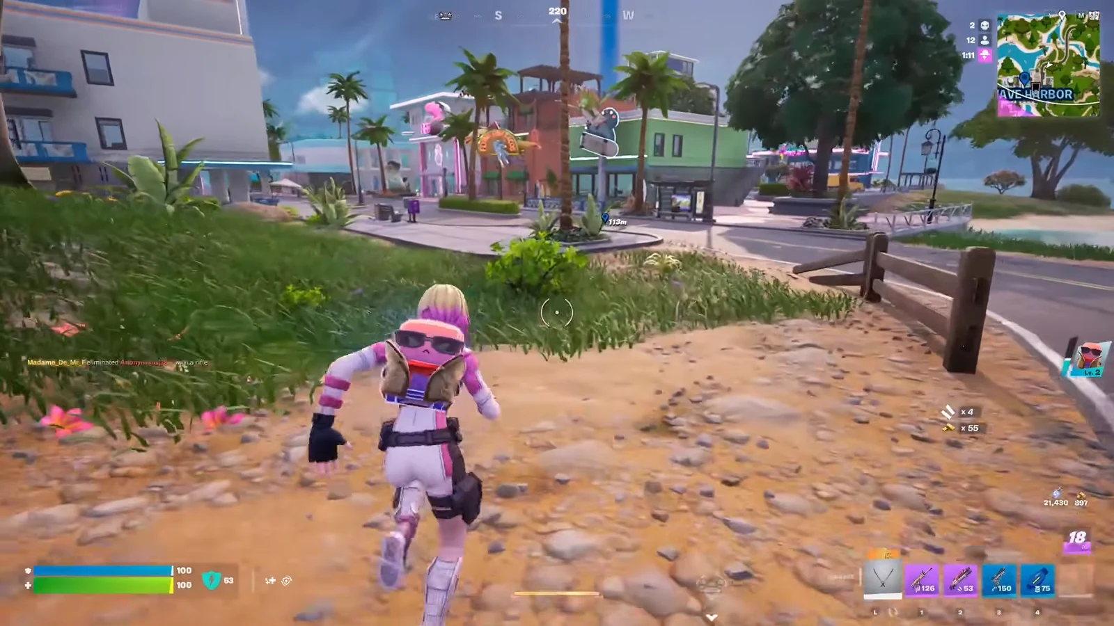 Fortnite player character running toward the harbor town buildings and waterfront