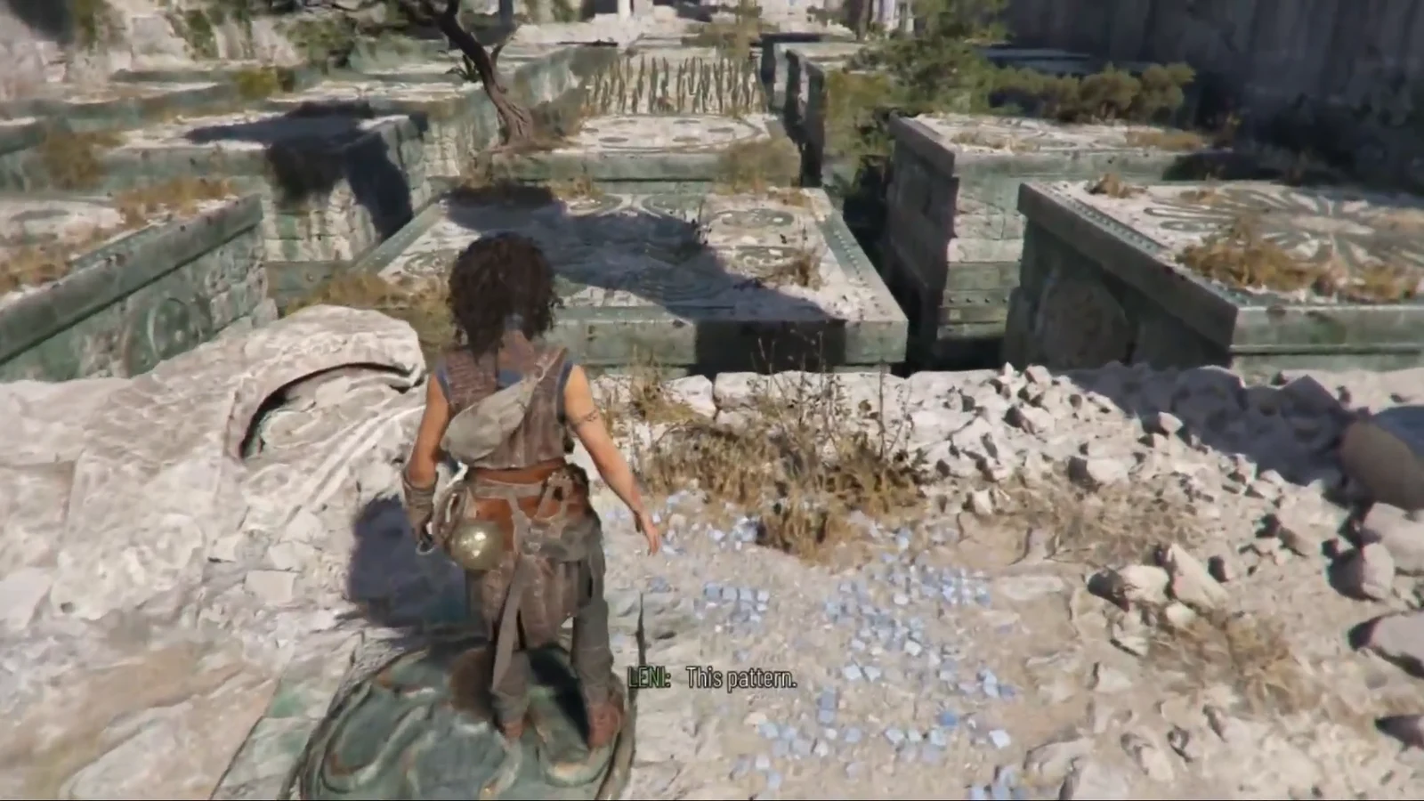 Leni studies the patterned stone tiles in the rooftop ruins to read the safe route