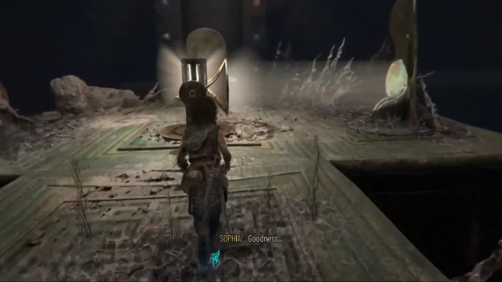 Sophia approaches a large circular metal mechanism at the end of a ruined platform