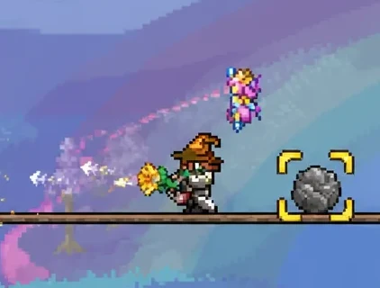 Terraria gameplay with yellow targeting brackets on a boulder as the player moves in close