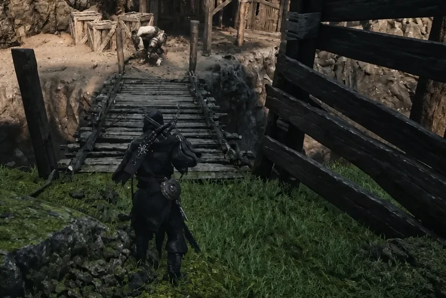 Player character walking toward a wooden bridge leading into a guarded mining area in Mammon