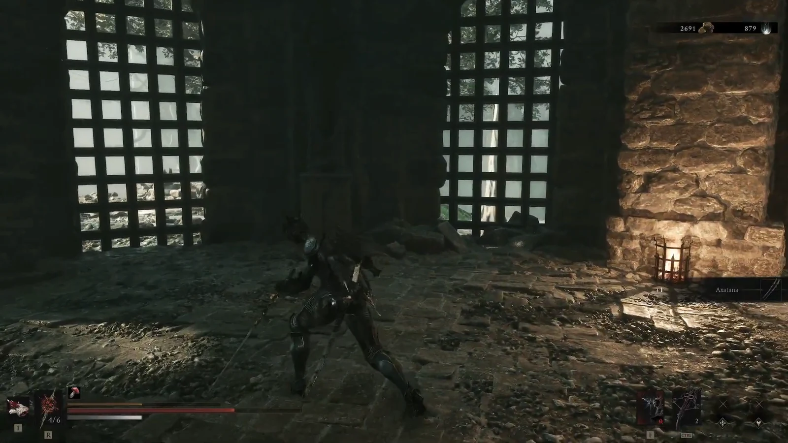 Player character holds the Axatana twin blades in a combat stance inside a dim stone chamber
