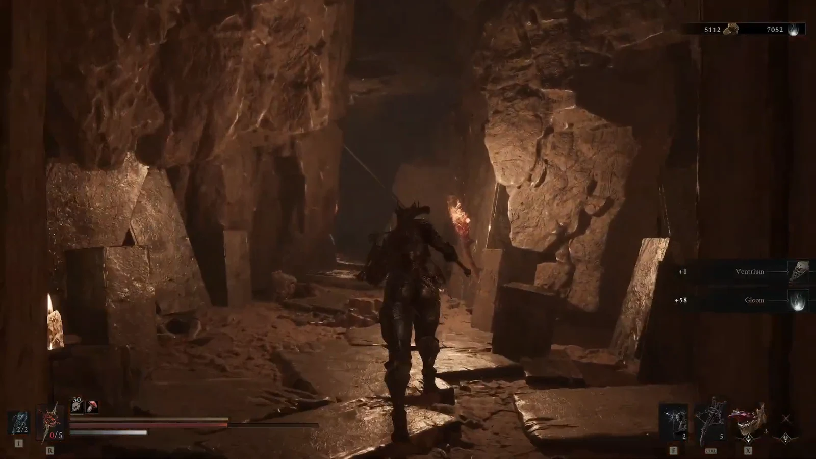 Character crossing a rocky cavern with pickup notifications for Ventrium and Gloom