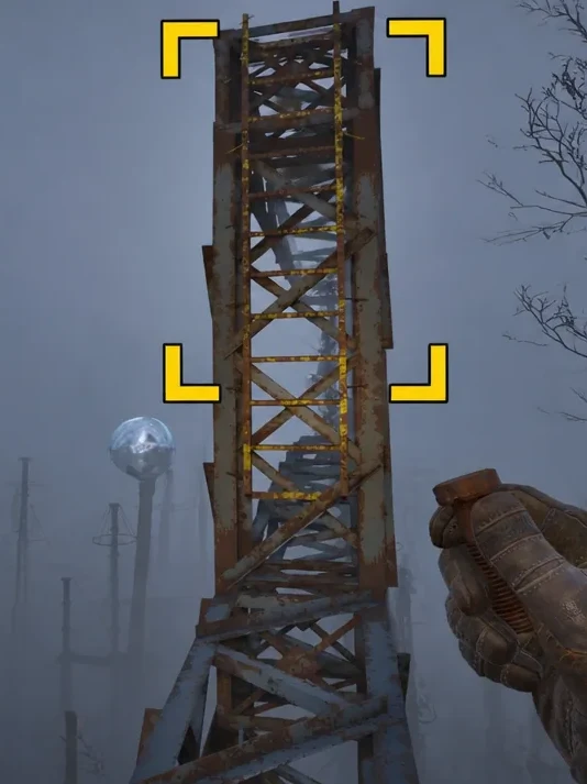 Skif aims up at the rusted tower ahead, highlighted with yellow targeting brackets