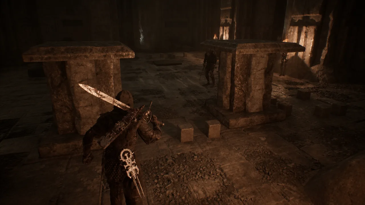 Armored warrior with a sword approaching an enemy inside a dim stone chamber
