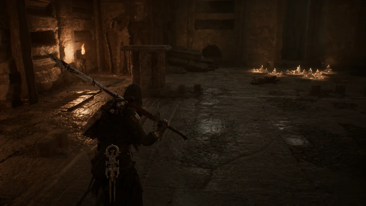 Player character exploring a candlelit stone dungeon room while holding a large sword