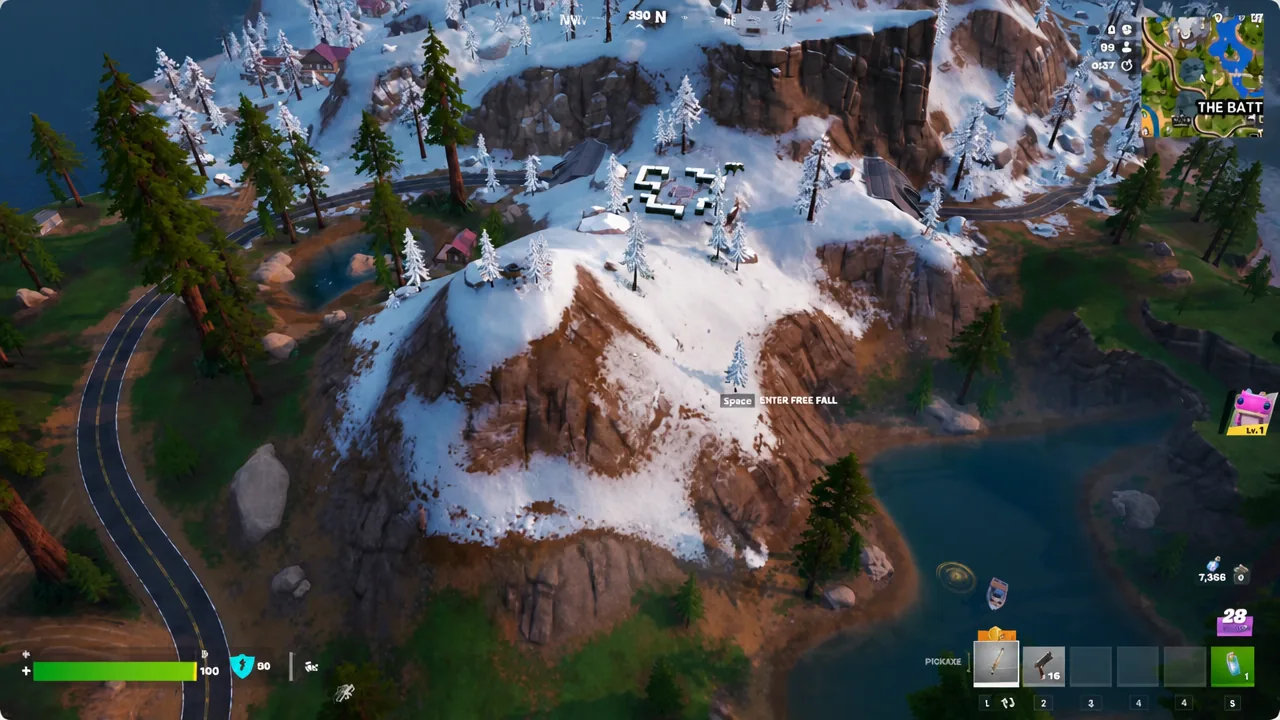 Free-fall prompt on screen while dropping toward a snowy mountain in Fortnite