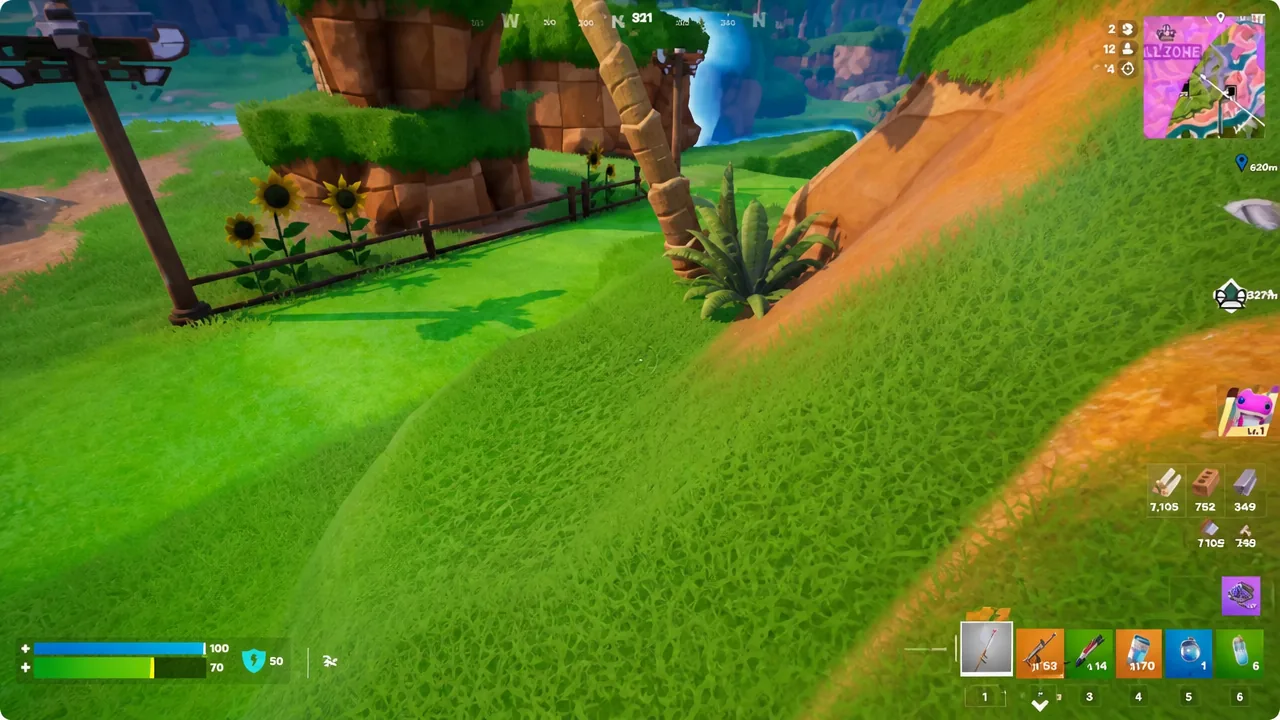 Fortnite player crossing an open grassy hillside with the harvesting tool equipped in slot one
