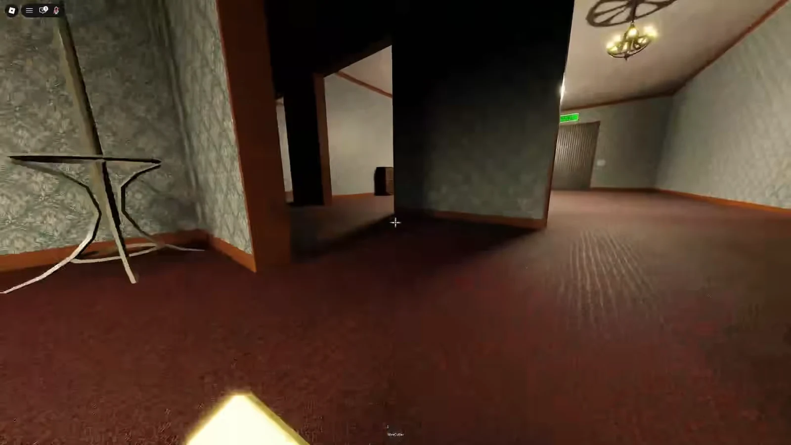 WireCutter equipped while heading down a carpeted hallway toward the exit door