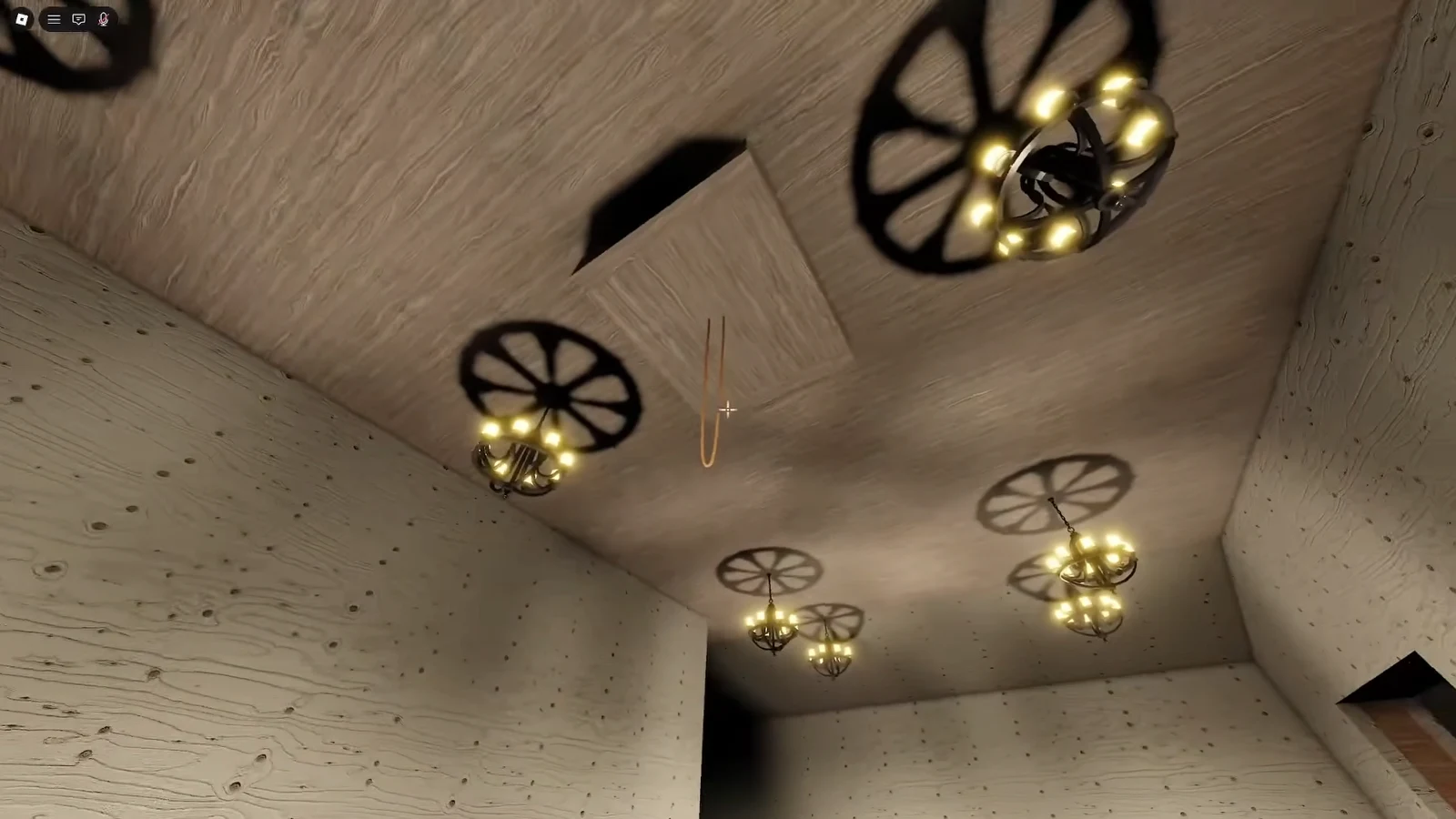 Looking up at glowing chandeliers in the wooden central room where the cube pads sit