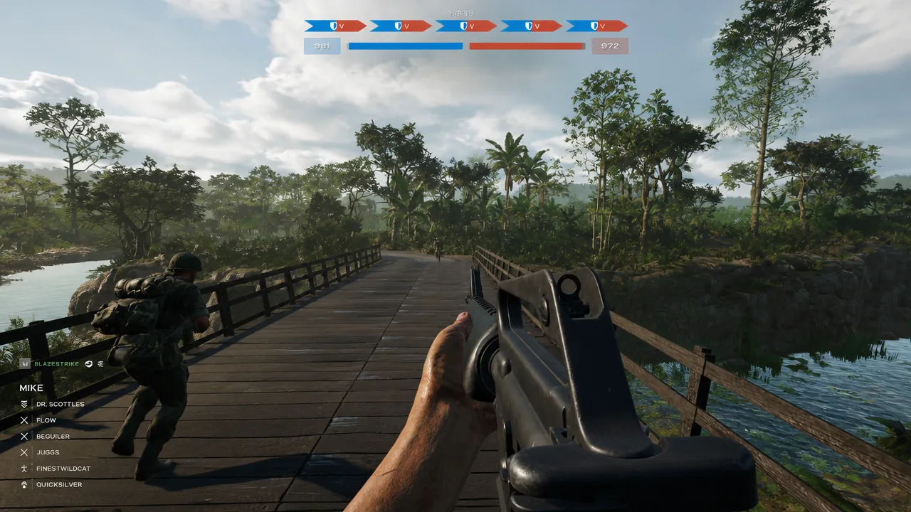 First-person view of a soldier holding a rifle crossing a wooden jungle bridge with a teammate ahead