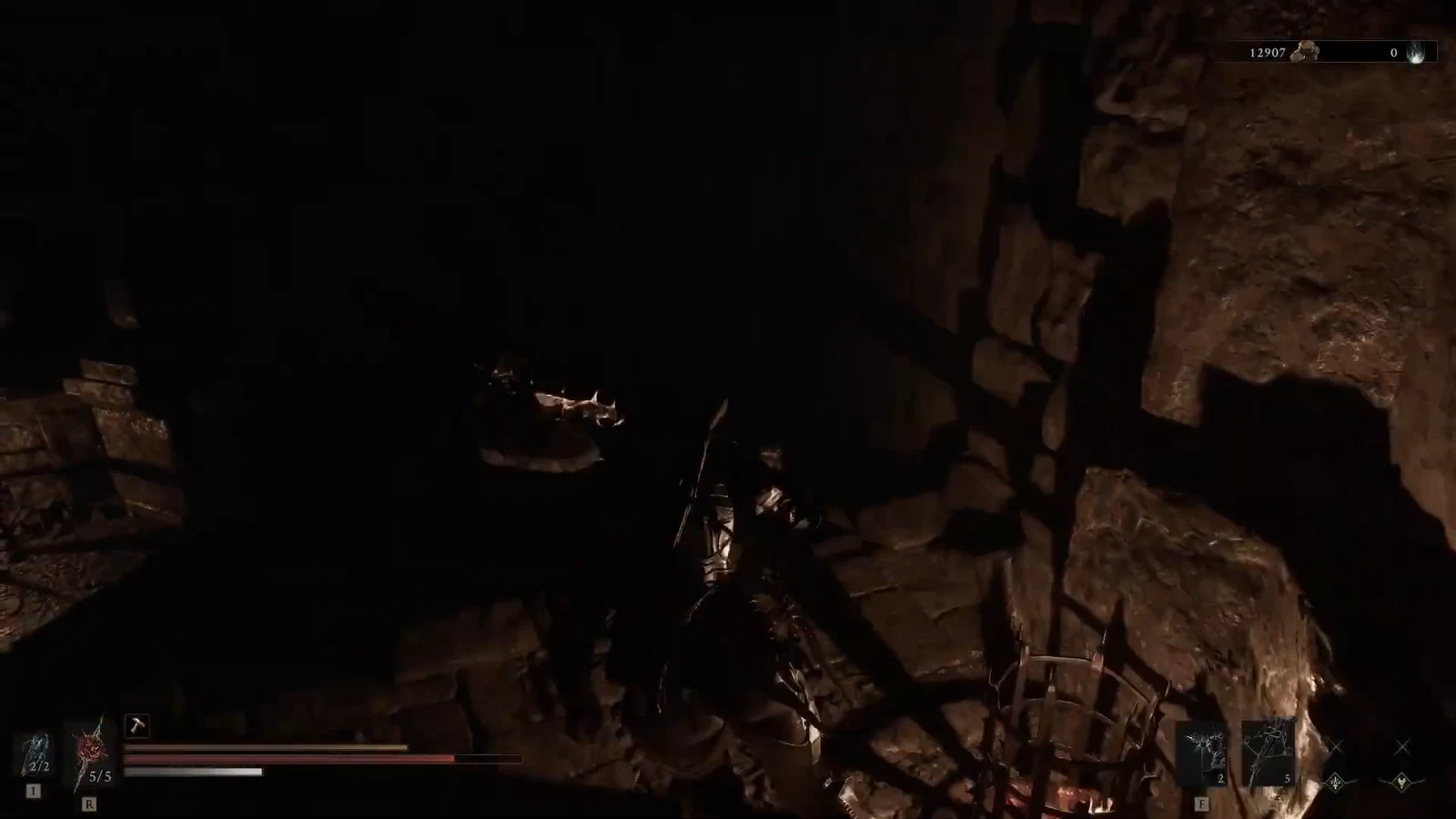Armored warrior fighting an enemy in a dark cave with health and stamina bars visible