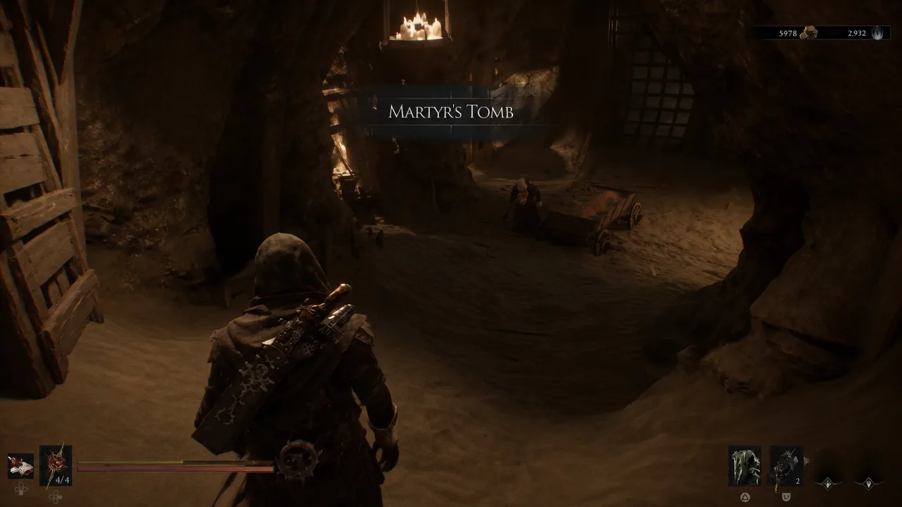 The Martyr's Tomb area title appears as the character enters the dim cavern