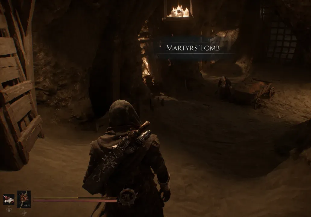 The Martyr's Tomb area title appears as the character enters the dim cavern