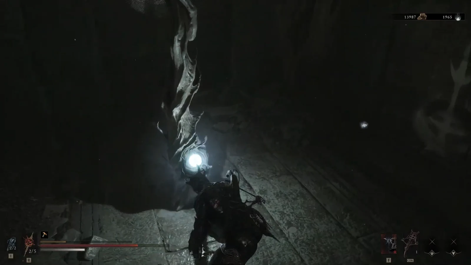 Player character attacking a glowing orb-like enemy in a dark cavern.