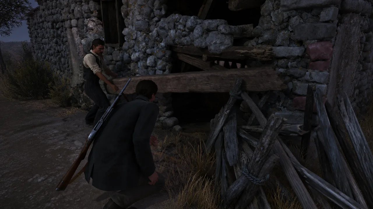 A crouching player character approaching a boarded opening in a stone wall while an armed companion stands nearby
