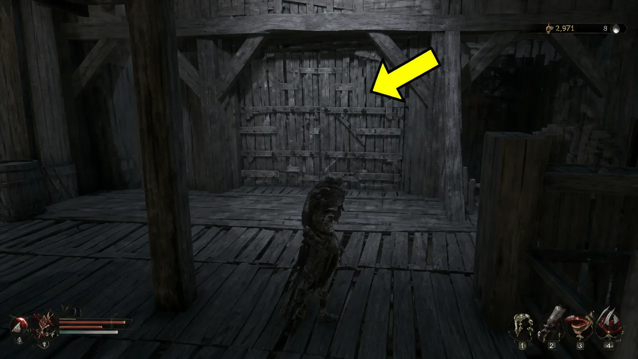 Closed wooden double door in the central village building, flagged with a yellow arrow before unlocking it