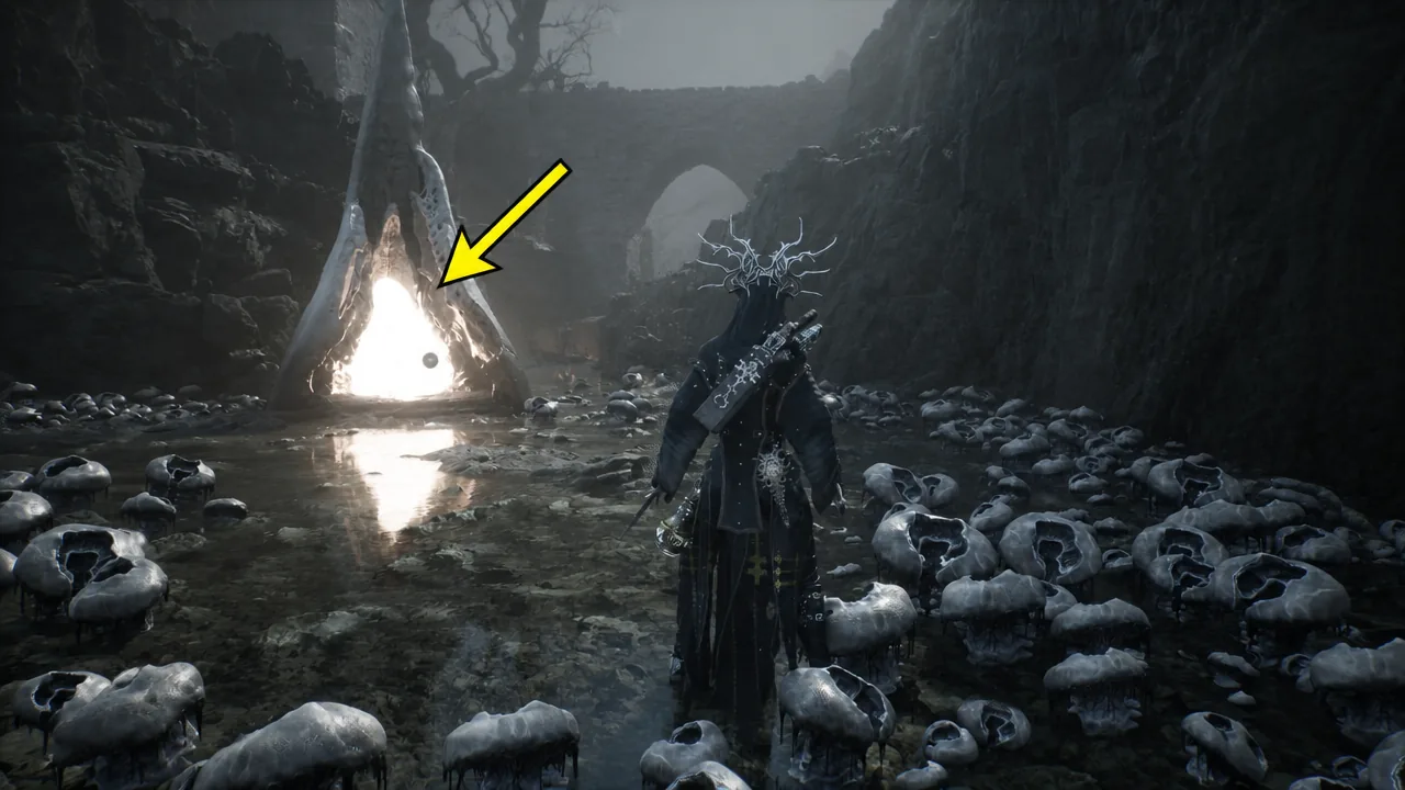 Marker pointing at the glowing triangular portal inside the skull-lined cavern of the Disciple's Path