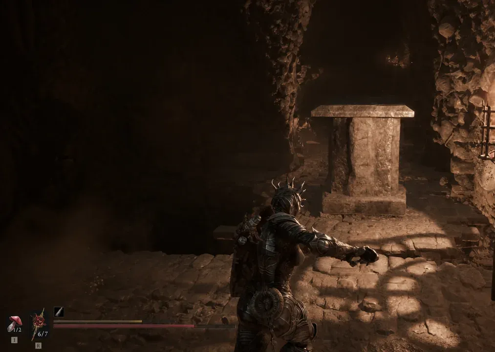 Armored character crosses the repaired cavern floor toward the movable stone pillar